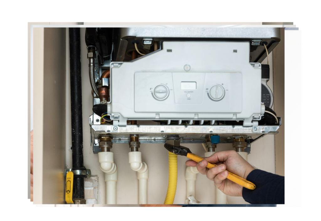 Technician installing a wall-mounted thermostat with heating system connections visible